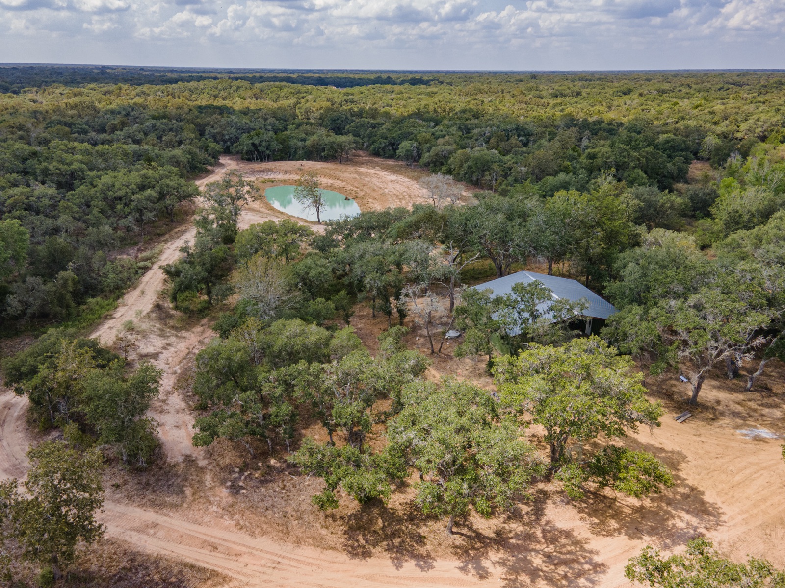 Hallettsville Weekend Retreat: Aerial of the pavilion, container houses, and pond